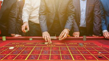 bigstock Group Of People Behind Roulett 323735470